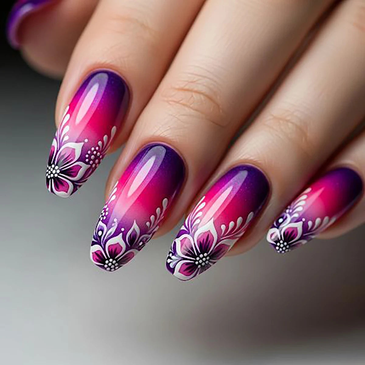 A full set of 24 medium-size coffin-shaped fake nails, crafted with gradient and smudge techniques and adorned with fuchsia flor
